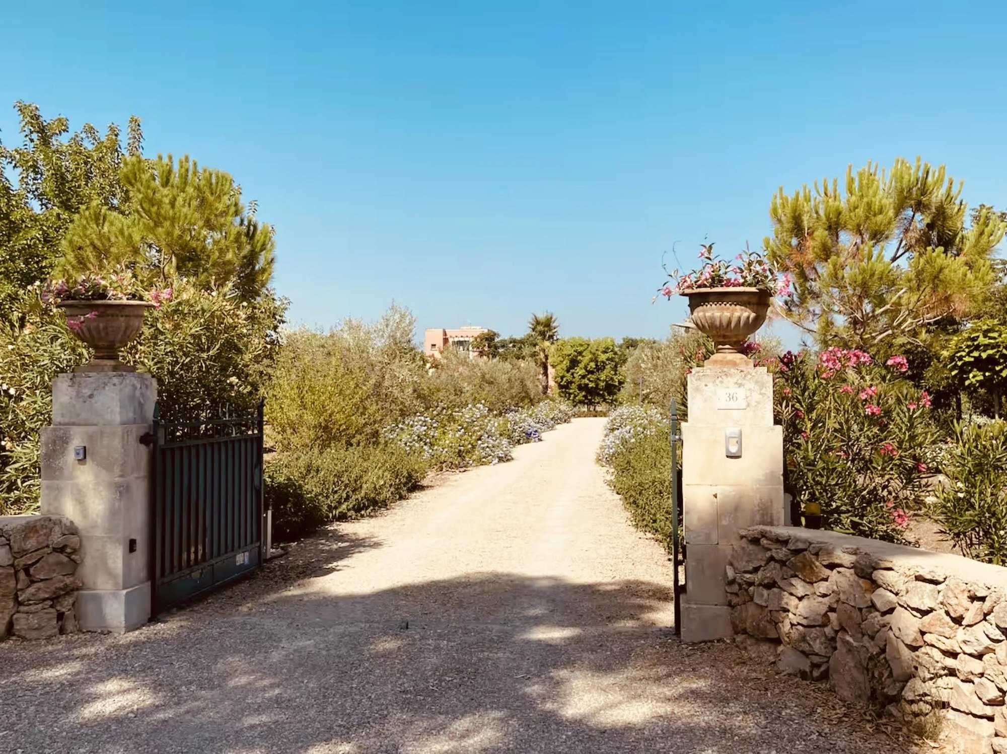 Eingangstor zur Villa Cafaro mit Oleander und Olivenbäumen